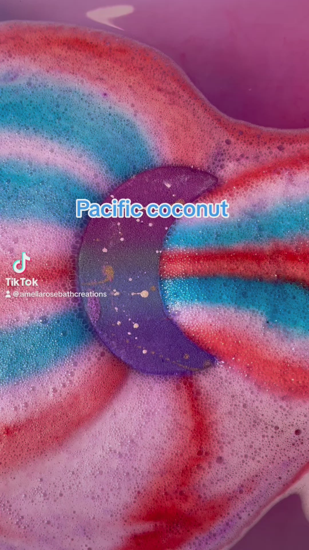 Load video: pacific coconut bath bomb with hidden colours inside